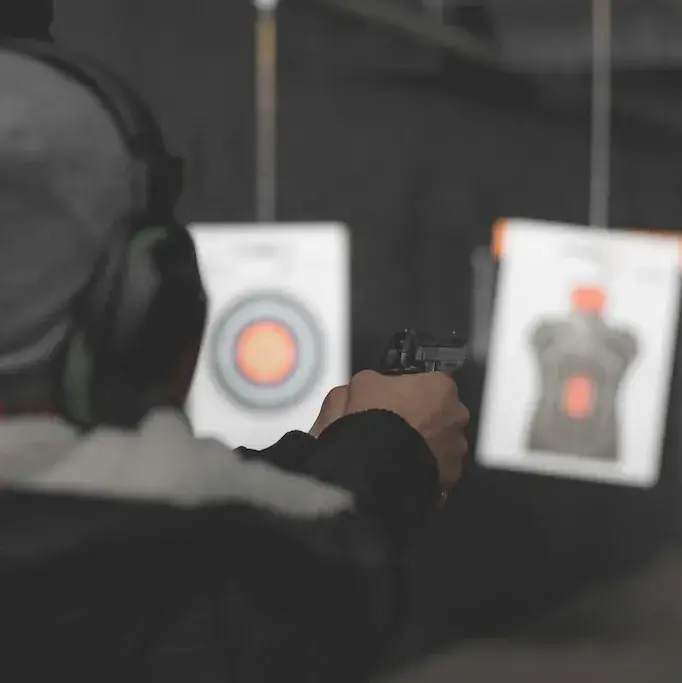 Man firing a gun at a target